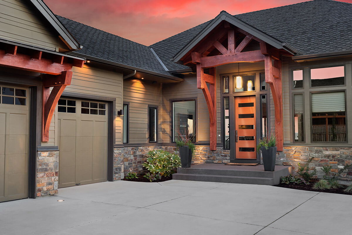 A modern front door with five glass inserts on a stunning home