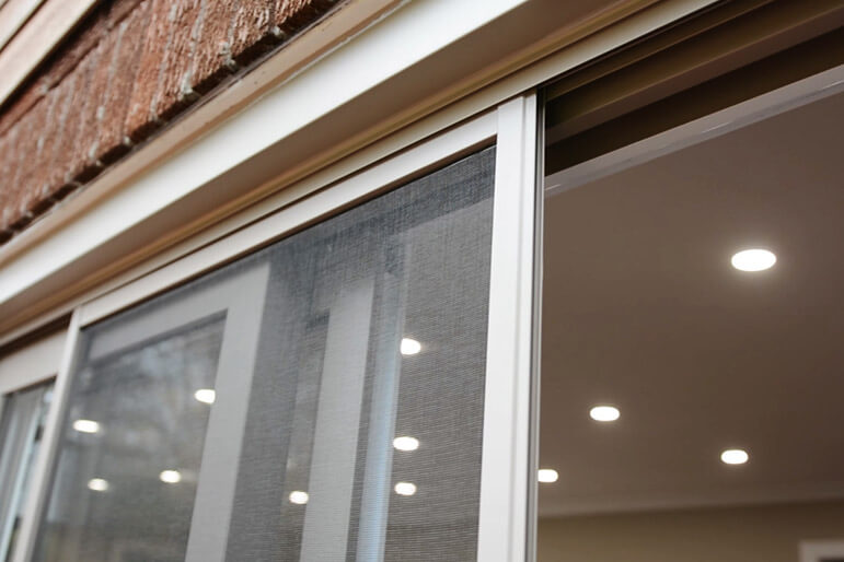 A close up of a patio door with PVC-wrapped wood.