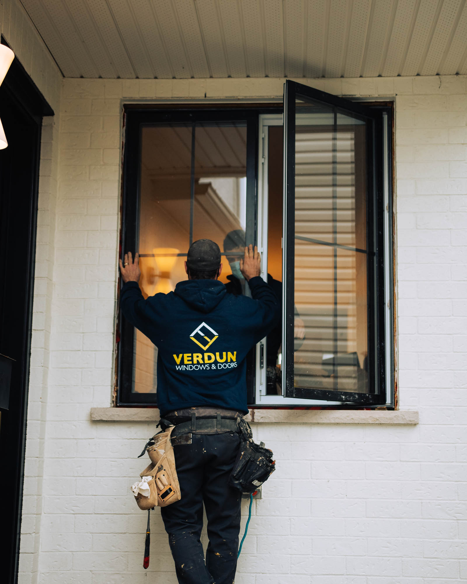 Open casement window showing the sash swung outward on hinges with a view of a suburban neighbourhood, demonstrating how a casement window sash operates